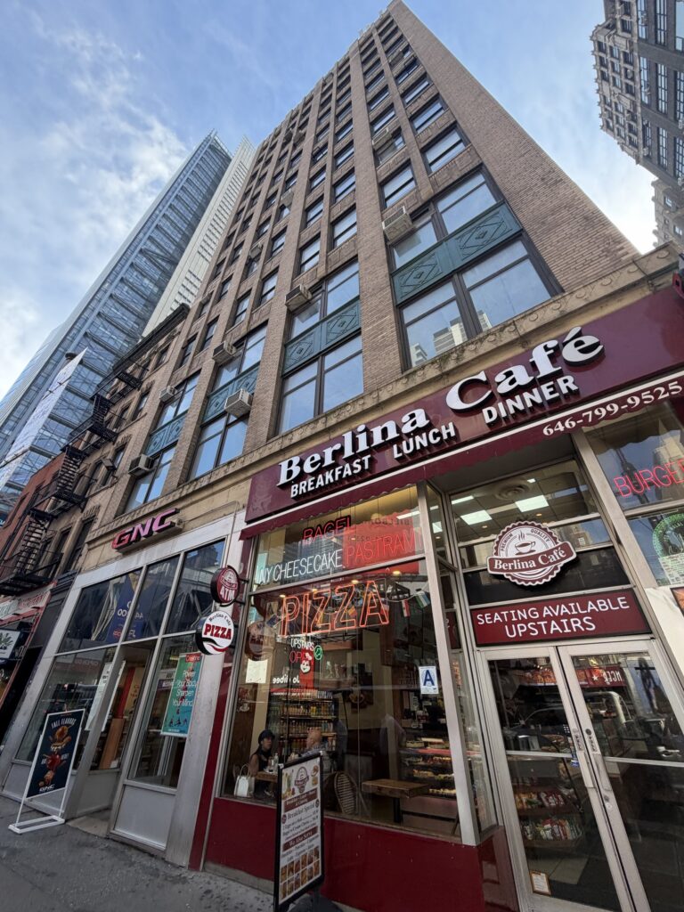 600 8th Avenue - ground-floor retail on Eighth Avenue, Berlina Cafe and GNC storefronts